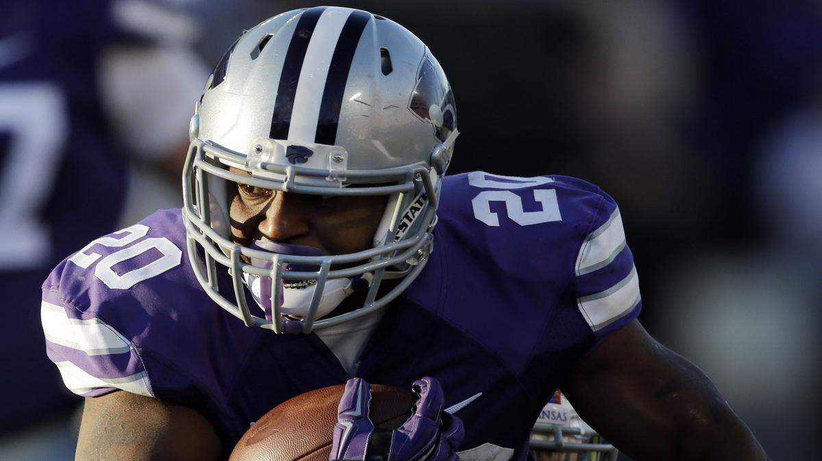 Kansas State running back DeMarcus Robinson (20) is tackled by Kansas linebacker Courtney Arnick, back, during the first half of an NCAA college football game in Manhattan, Kan., Saturday, Nov. 29, 2014. 