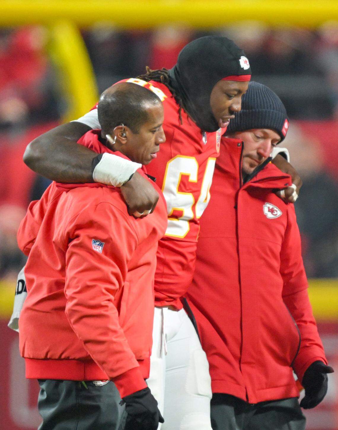 Kansas City Chiefs offensive tackle Wanya Morris (64) is helped off the field early in the first quarter of the game against the Houston Texans at GEHA Field at Arrowhead Stadium on Sunday, Dec. 7, 2025.