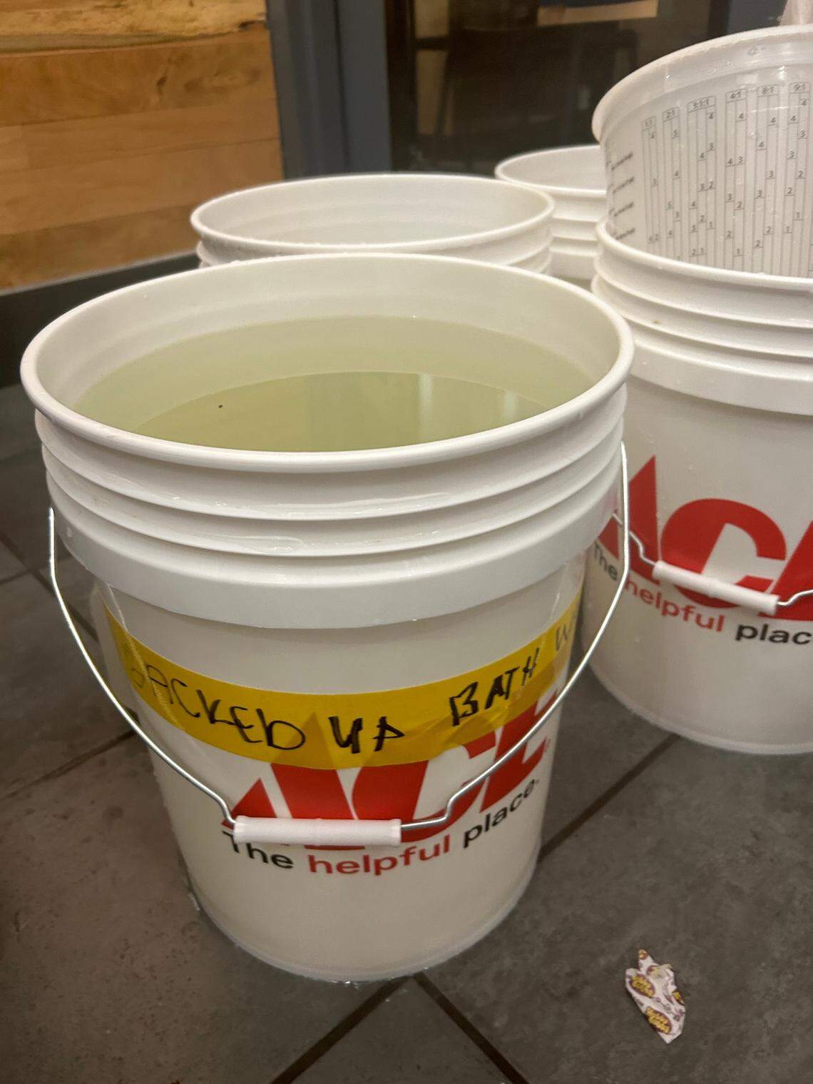 Residents of Quality Hill Towers collected tainted bath water to display outside building managers’ office door during an Oct. 18 labor action.