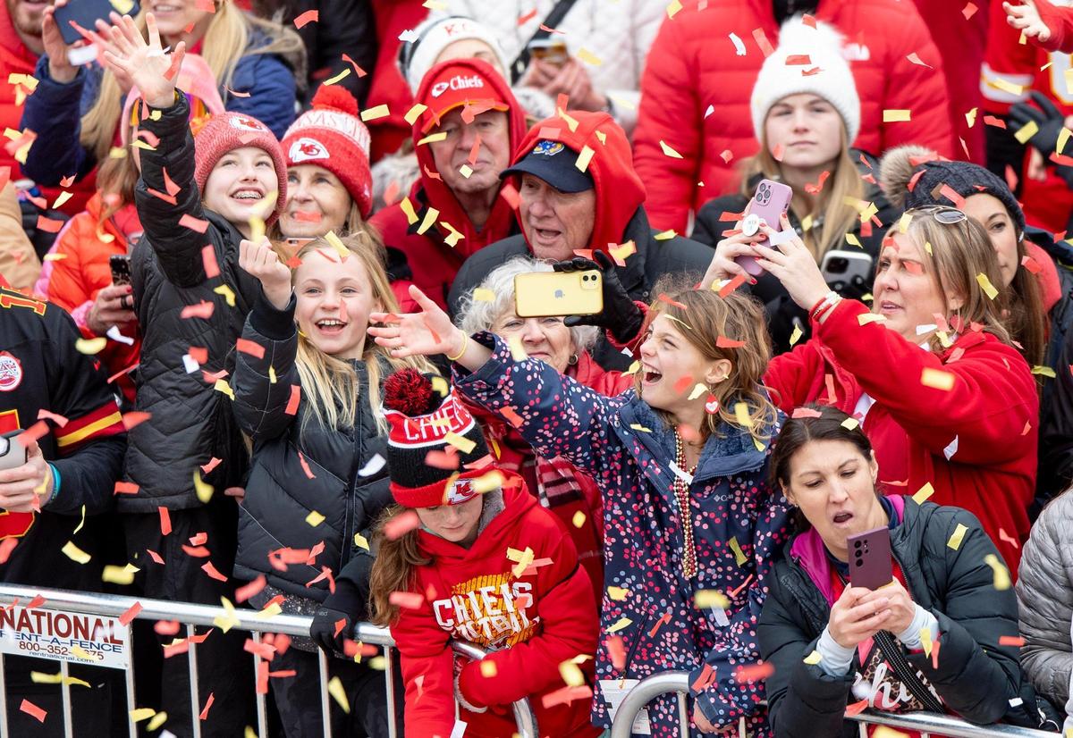 Chiefs fans reach for confetti during the Kansas City Chiefs Super Bowl victory parade on Wednesday, Feb. 15, 2023, in Kansas City.