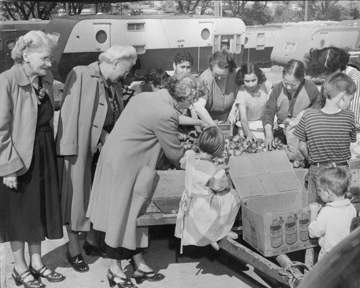 Volunteers deliver food to residents of a temporary trailer village established near Argentine after the flood.