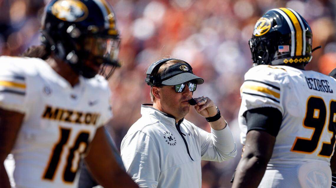 Missouri Tigers coach Eliah Drinkwitz talks with his players during a timeout last Saturday at Auburn.
