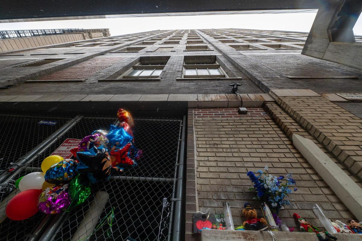 A makeshift memorial is seen along an alley Friday near East 10th Street and Grand Boulevard in Kansas City. The memorial was set up for 5-year-old Grayson O’Connor who died after falling from a window of the Grand Boulevard Lofts on Nov. 27.