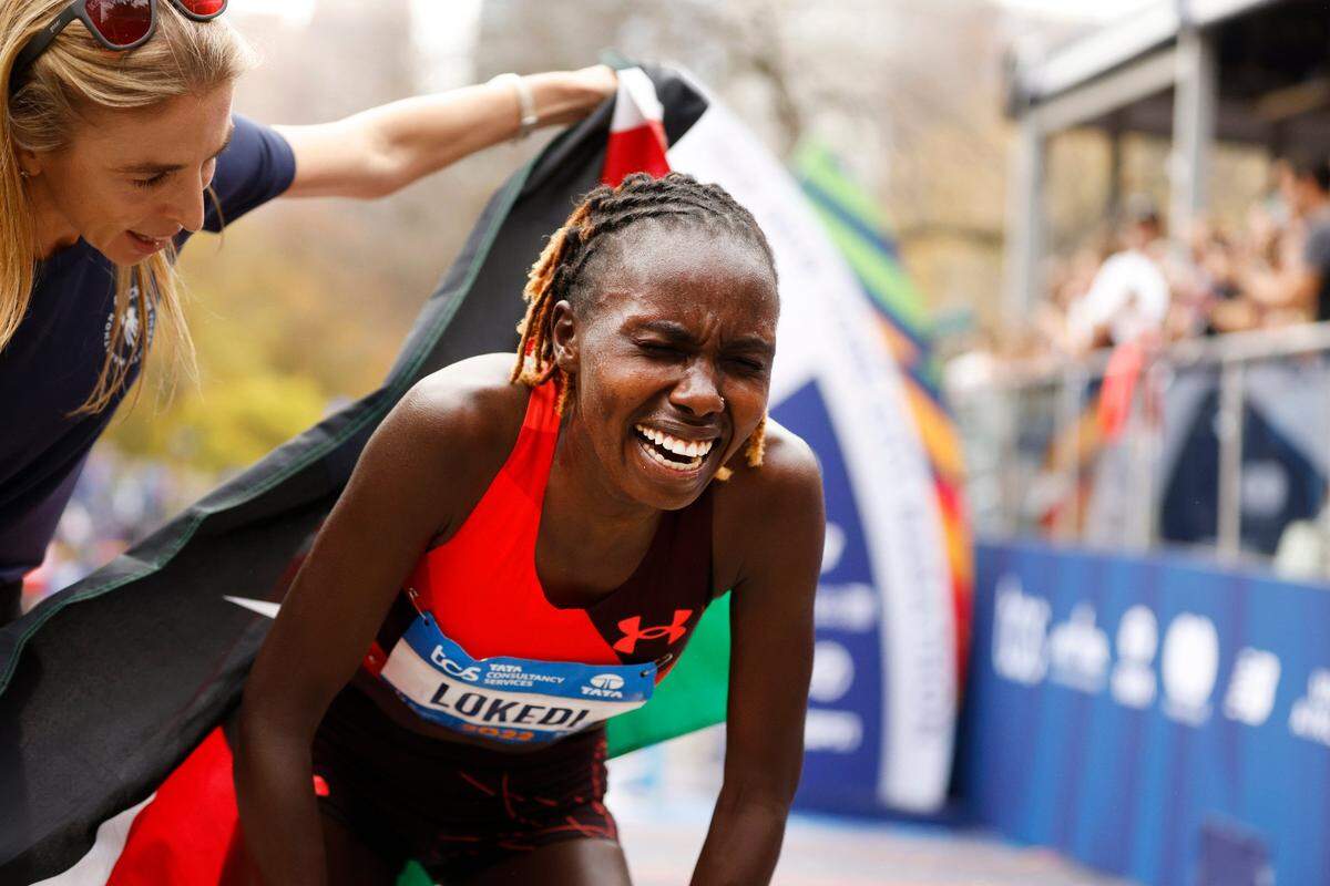 Sharon Lokedi, of Kenya, catches her breath after crossing the finish line first in the women’s division of the New York City Marathon on Sunday.