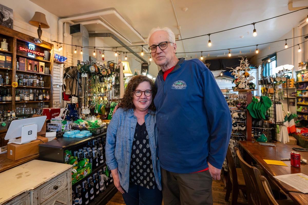 Kerry Browne and John McClain, are the co-owners of Browne’s Irish Marketplace. The market is the oldest continuous Irish business outside of Ireland. The business was started by Edward and Mary Flavin in 1887. The business was passed on to the Flavin’s daughter Margaret who was the wife of Kerry’s great-grandfather Jim Browne.