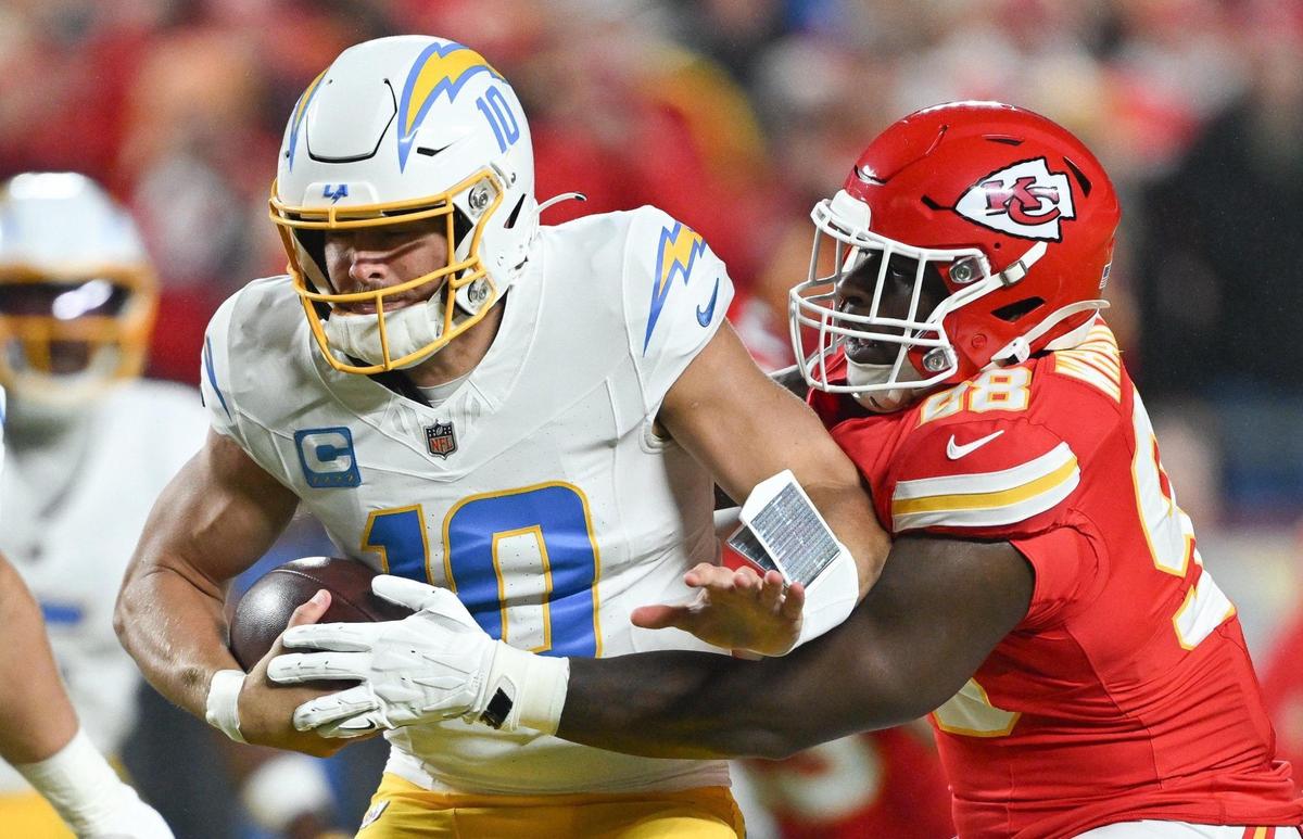 Kansas City Chiefs defensive tackle Tershawn Wharton (98) sacks Los Angeles Chargers quarterback Justin Herbert (10) in the first quarter on Sunday, Dec. 8, 2024, at GEHA Field at Arrowhead Stadium.