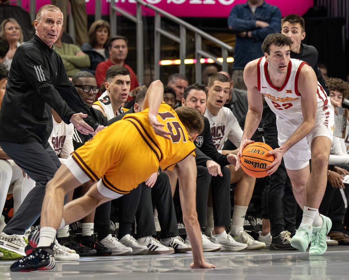 Arizona State guard Noah Meeusen (15) slips as Iowa State forward Milan Momcilovic (22) catches the ball before it goes out of bounds during the first half of a Big 12 men's basketball tournament game at T-Mobile Center on Wednesday, March 11, 2026, in Kansas City.