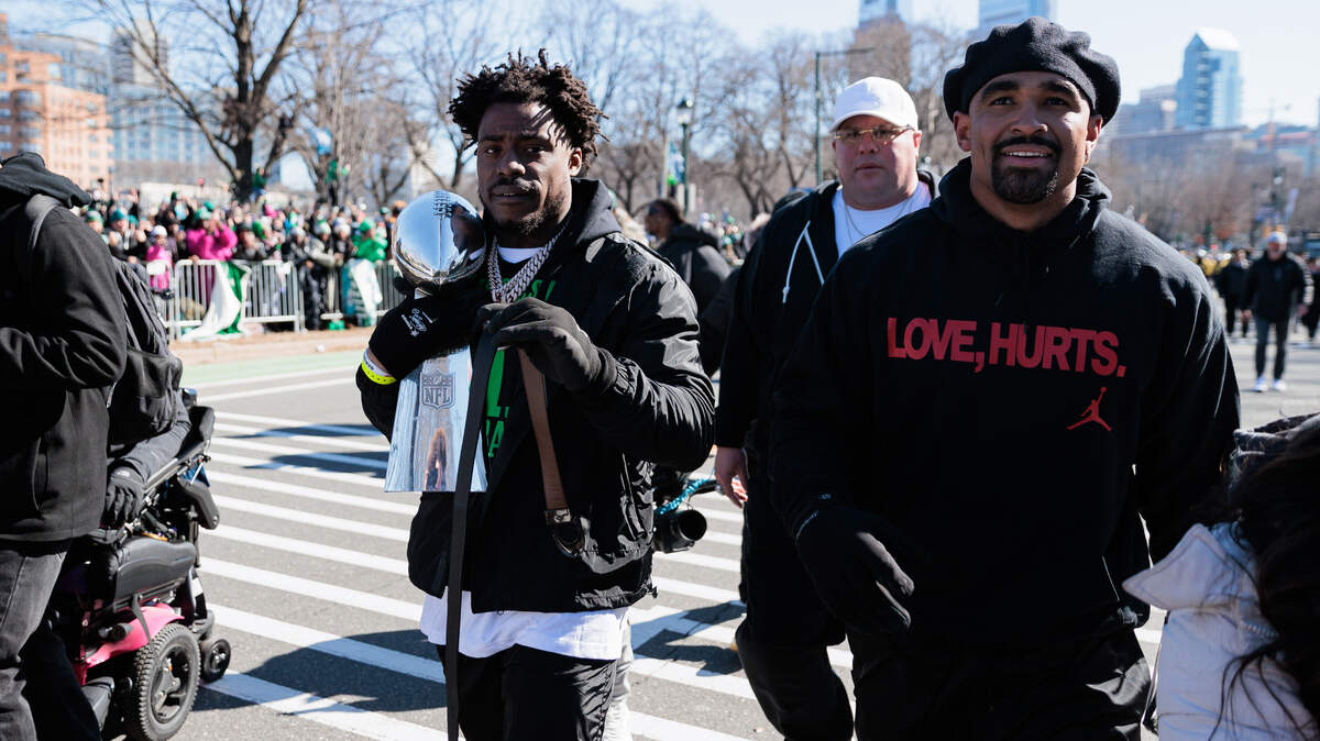 Philadelphia Eagles safety C.J. Gardner-Johnson (8) carries the Lombardi Trophy alongside quarterback Jalen Hurts (1) during the Super Bowl LIX championship parade and rally.