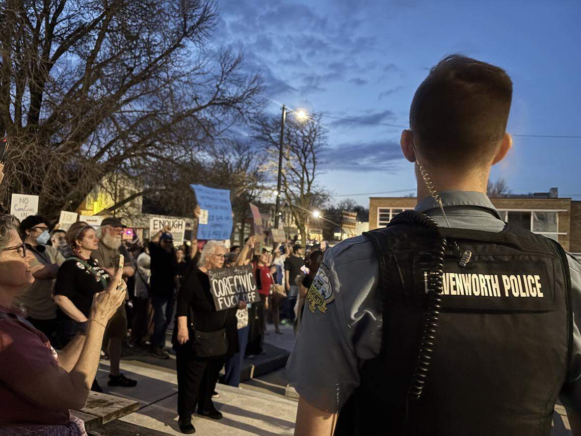 Protesters demonstrate against an immigration detention center at Leavenworth City Hall on Tuesday, March 10. While the city commission voted to approve CoreCivic’s repurposing of a prison for immigration enforcements, the crowd of protesters was met with several police officers.