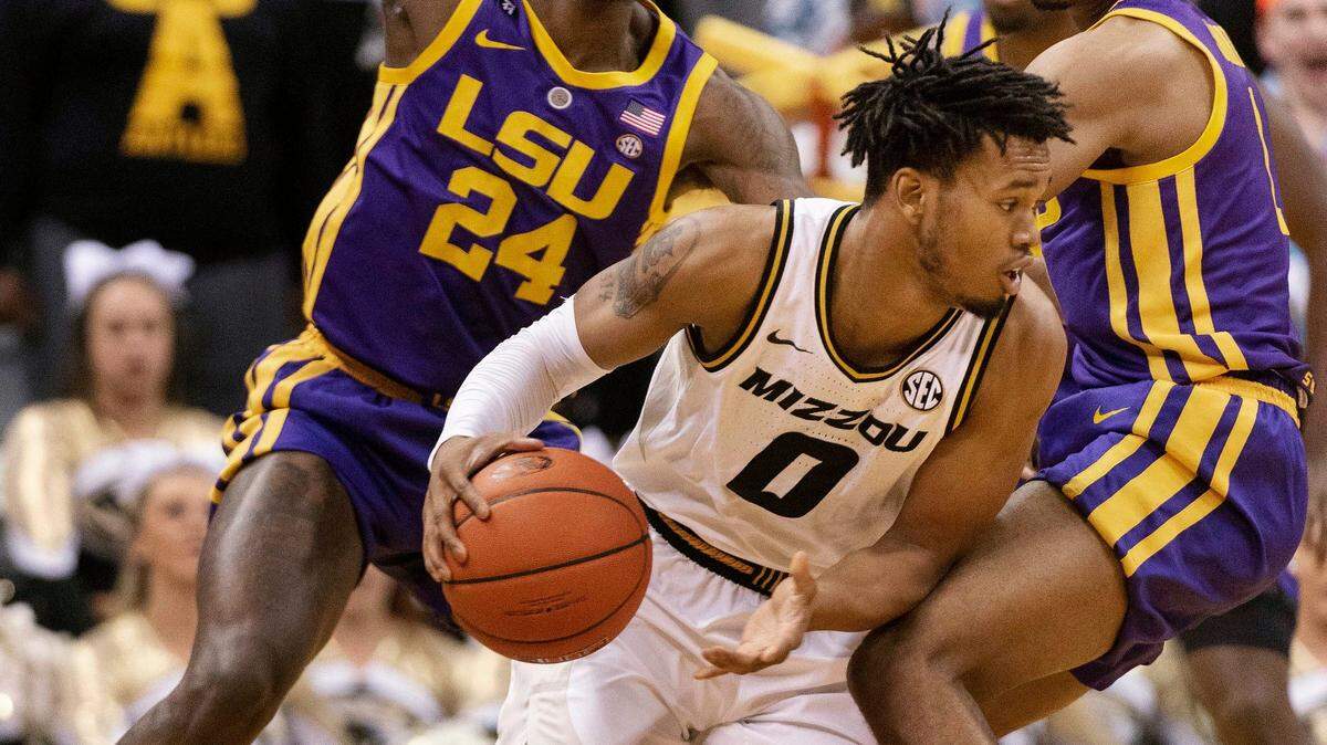 Missouri’s Torrence Watson, center, dribbles around LSU’s Emmitt Williams, left, and Ja’vonte Smart during the first half of an NCAA college basketball game Saturday, Jan. 26, 2019, in Columbia, Mo. (AP Photo/L.G. Patterson)