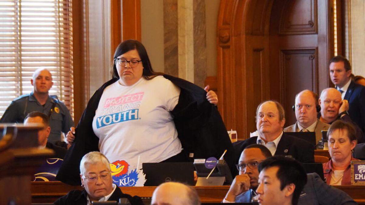 Rep. Heather Meyer, an Overland Park Democrat, displayed her “PROTECT TRANS KIDS” shirt on the House floor Wednesday. Meyer has a transgender child.