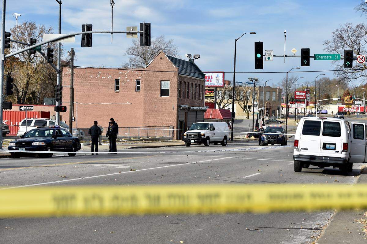 Police investigate a homicide Wednesday at Linwood Boulevard and Charlotte Street in Kansas City.