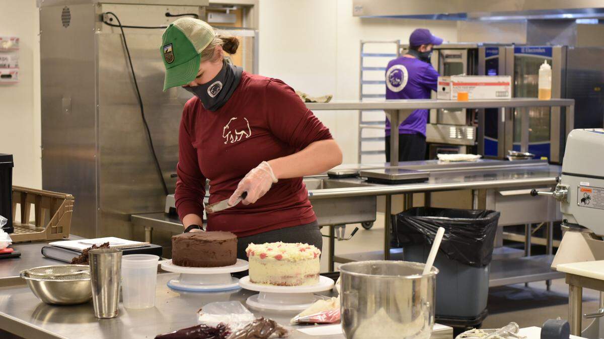 Natalie Olds frosts a chocolate blackberry cake in a kitchen of the Food Innovation Accelerator at K-State Olathe. She and her husband, Jabin Olds, started Three Bears Bakery & BBQ to produce baked goods that are free of sugar, low in carbohydrates and high in protein.