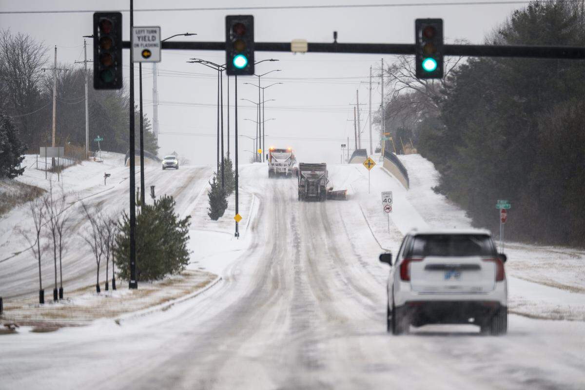 Drivers navigate in snowy conditions during a winter storm Saturday, Jan. 24 2026, in Lenexa.