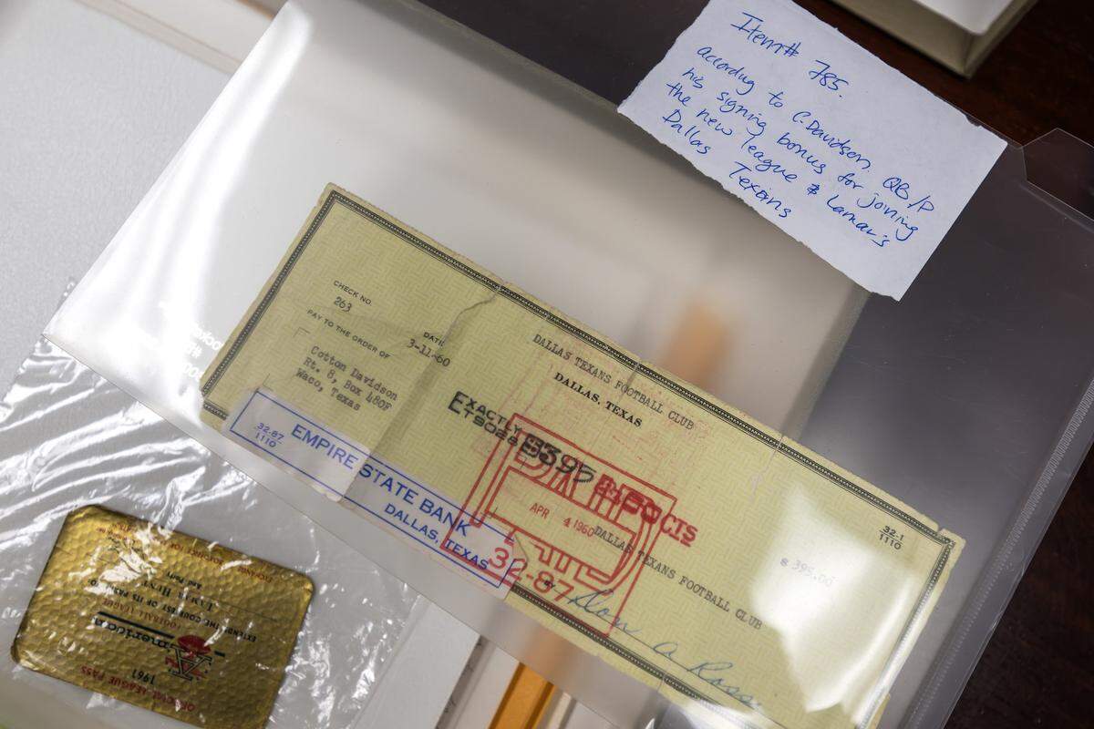 A check for a signing bonus, made out to quarterback Cotton Davidson, is displayed inside a plastic protective sheet at the Kansas City Chiefs' underground storage facility in Kansas City.