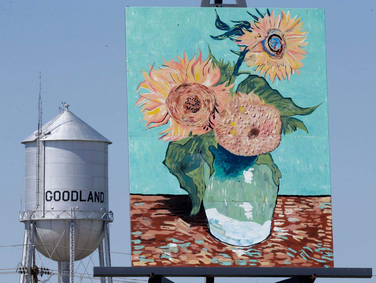 An 80-foot reproduction of Vincent van Gogh’s “Three Sunflowers in a Vase” known as the “Big Easel” stands near a water tower in Goodland, Kan., Monday, May 11, 2015. The attraction was introduced to celebrate the community’s connection to art and agriculture. (AP Photo/Orlin Wagner)