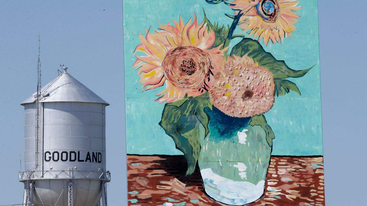 An 80-foot reproduction of Vincent van Gogh’s “Three Sunflowers in a Vase” known as the “Big Easel” stands near a water tower in Goodland, Kan., Monday, May 11, 2015. The attraction was introduced to celebrate the community’s connection to art and agriculture. (AP Photo/Orlin Wagner)
