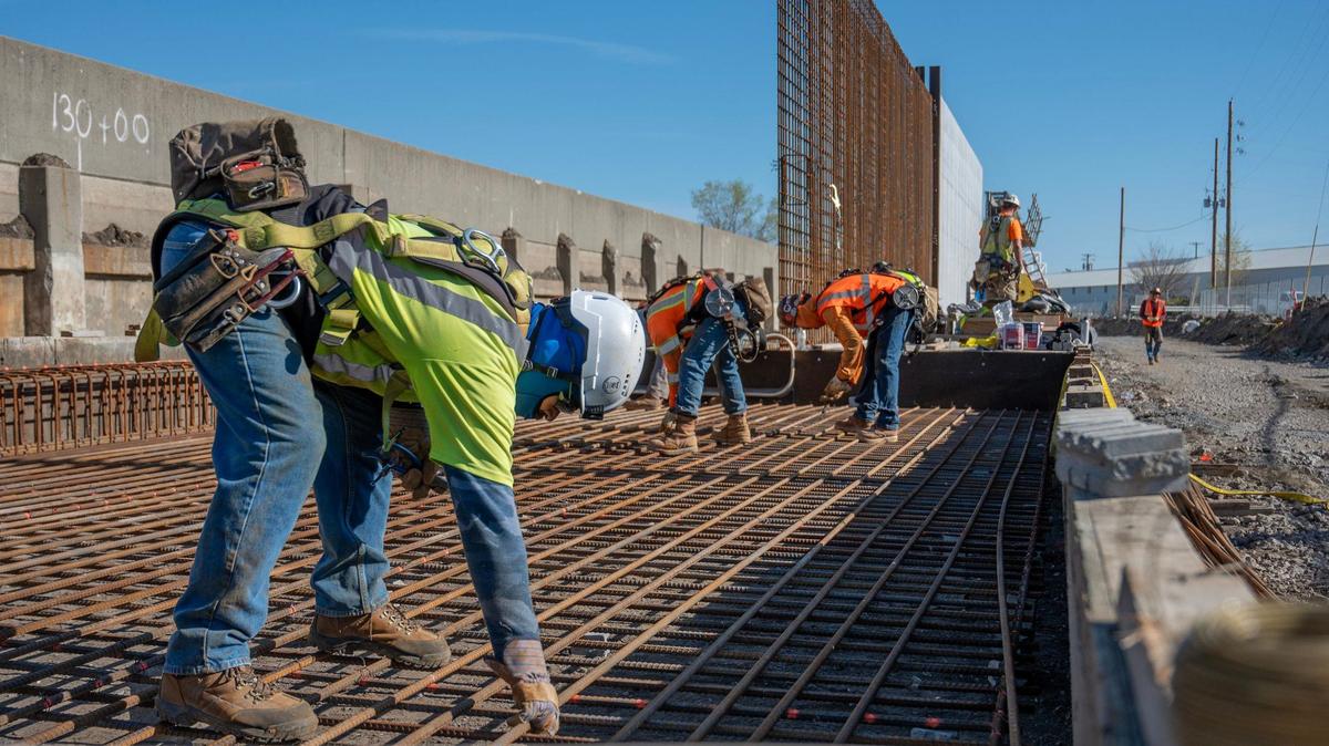 An Epic Concrete Construction crew assembles rebar in preparation for pouring concrete for the Kansas City Levees Project along the Central Industrial District, which straddles the state line.
