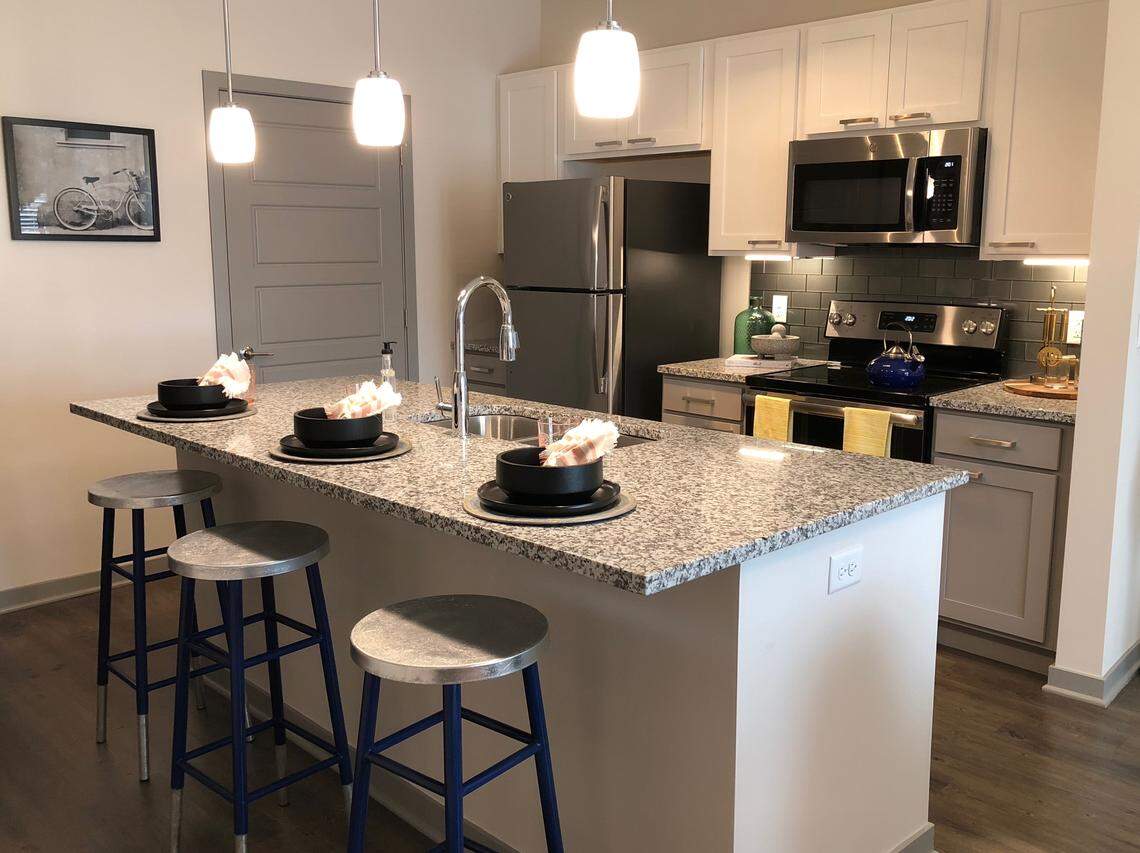 The kitchens at Crossroads Westside Apartments were designed with high-end finishes such as two-tone Shaker cabinets, granite countertops and stainless steel appliances.