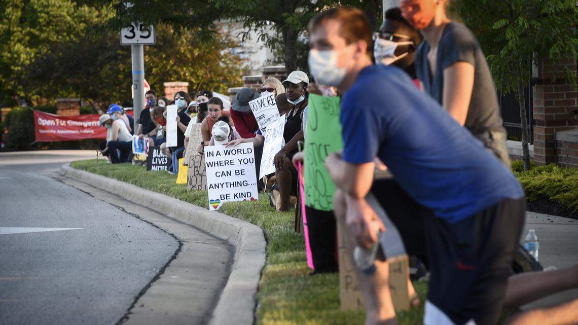 Protesters kneeled for eight minutes of silence at a Black Lives Matter George Floyd rally Sunday near 95th Street and Antioch Road in Overland Park.