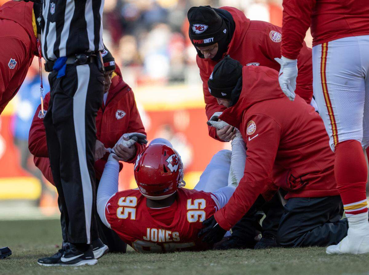 The training staff attends to Kansas City Chiefs defensive tackle Chris Jones (95) who went down in the second half against the Los Angeles Chargers on Sunday, Dec. 14, 2025 at GEHA Field at Arrowhead Stadium in Kansas City. The Chargers defeated the Chiefs, 16-13.