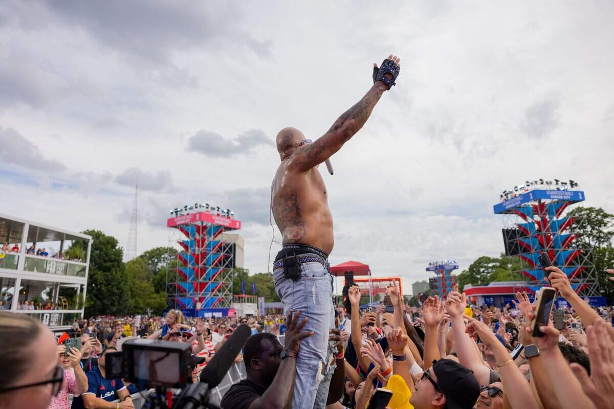 Flo Rida holds their arms up to the crowd during their FIFA Fan Fest concert at Fan Fest on Friday, June 19, 2026.