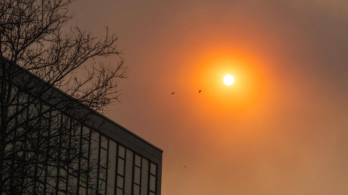 Dust and smoke from wildfires in Oklahoma blown by high winds obscure the sun on March 14 in Kansas City.