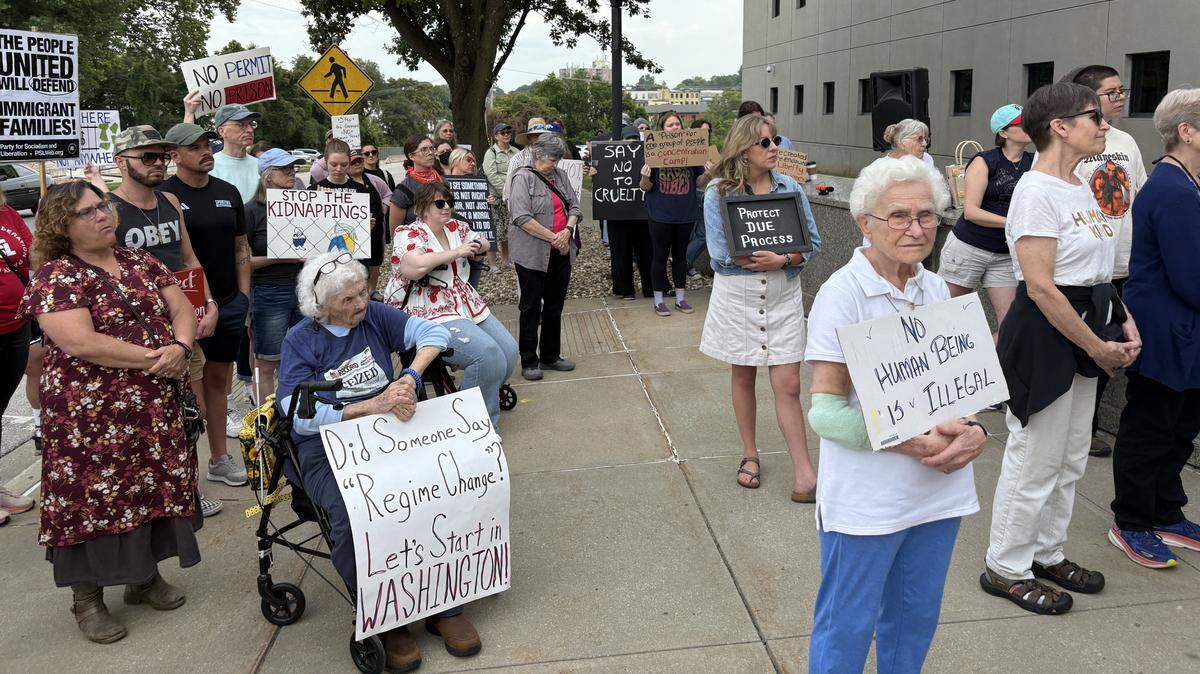 Demonstrators gathered outside the Leavenworth courthouse to protest CoreCivic’s plans to reopen a shuttered facility on the outskirts of town as an immigrant detention center.