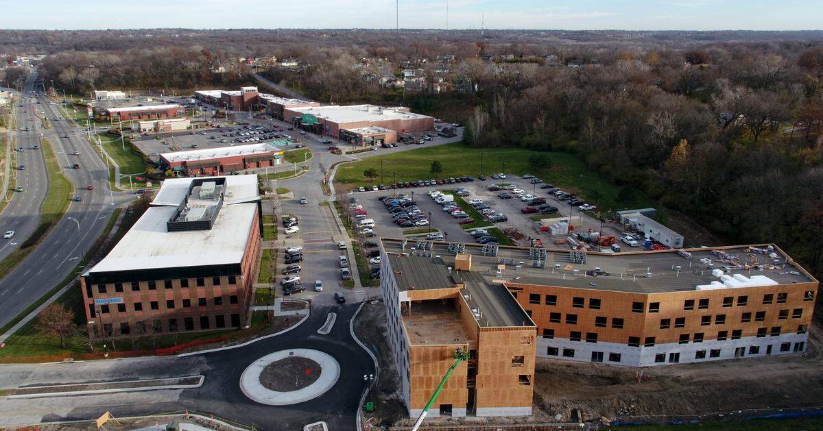 Community Builders of Kansas City has done extensive work on Kansas City’s East Side, including the office building on Blue Parkway, at left, a new apartment complex, bottom right, and a shopping center, top.