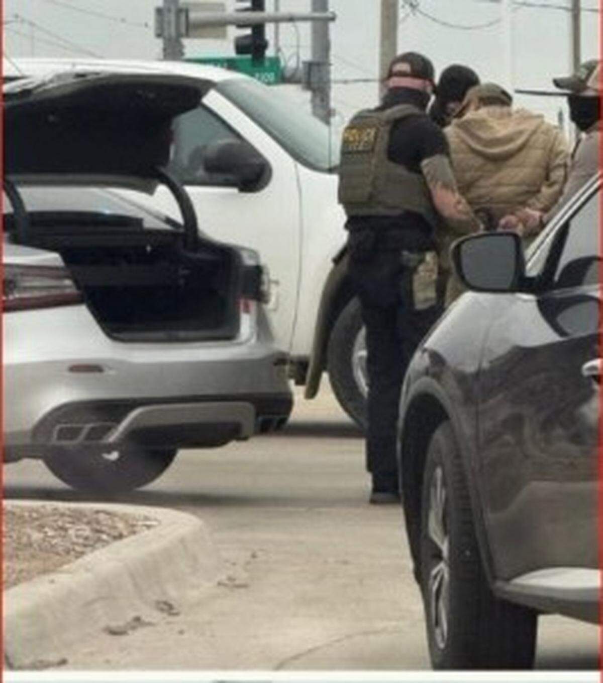 Immigration agents detain a person in Lawrence on Tuesday, Feb. 17, 2026, according to images captured by Sanctuary Alliance.