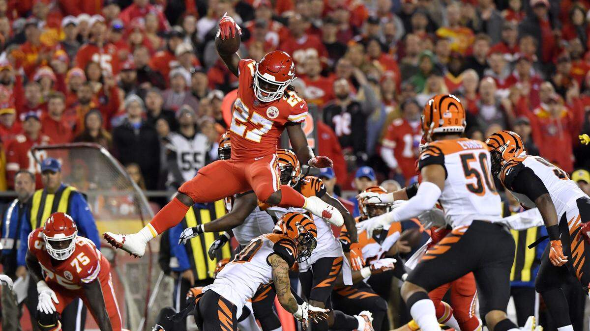 Chiefs running back Kareem Hunt leaps over the Bengals’ Jessie Bates on an incredible run Sunday evening at Arrowhead.
