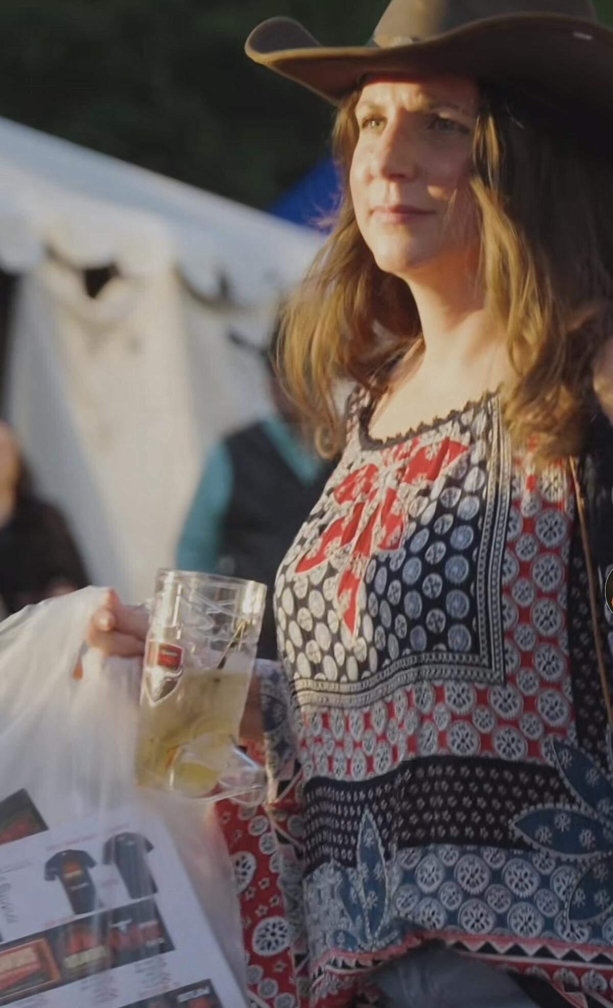 An Outlaws fan fan topped a boho ensemble of peasant shirt and jeans with a brown cowboy hat.