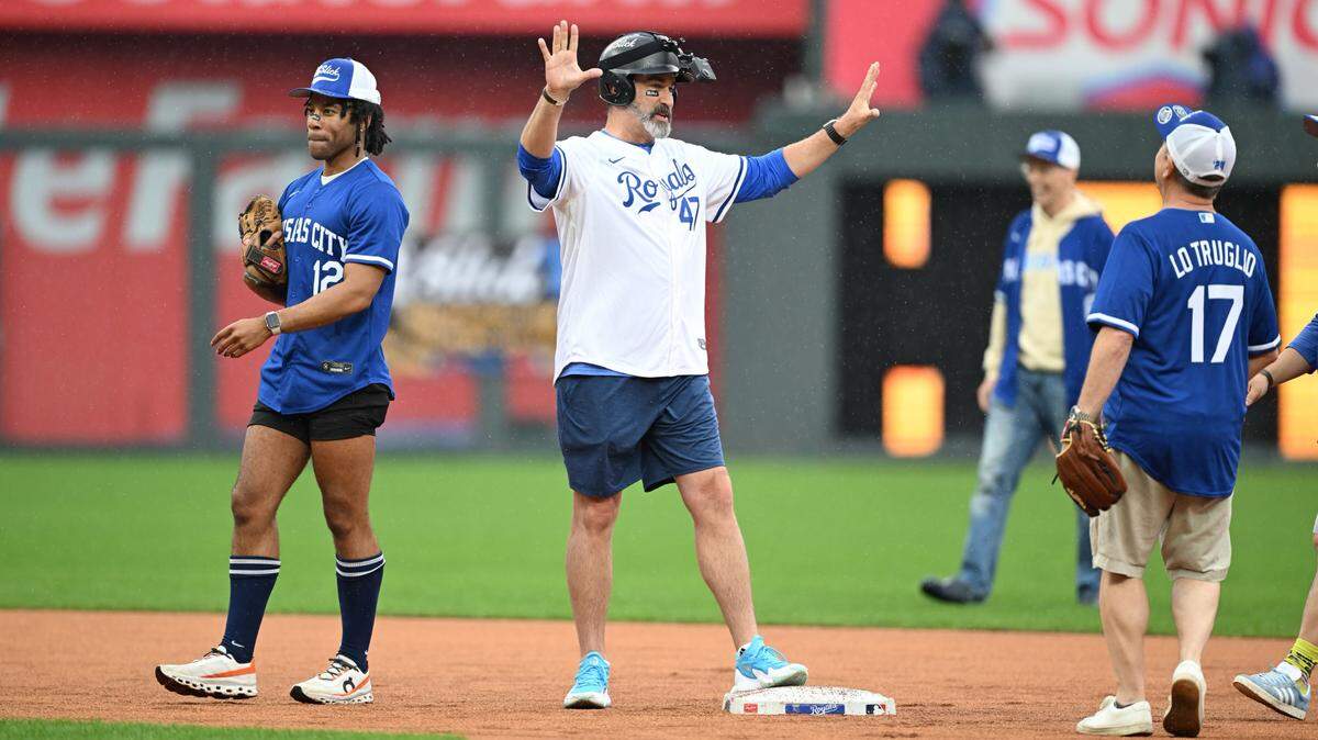 Rob Riggle, center, celebrates after getting on base during the Big Slick Celebrity Softball Game Friday at Kauffman Stadium.
