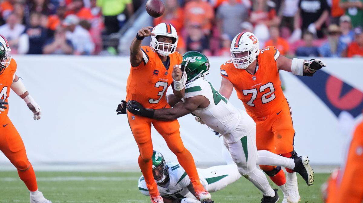 New York Jets linebacker Bryce Huff (47) tackles Denver Broncos quarterback Russell Wilson (3) in the second half at Empower Field at Mile High.