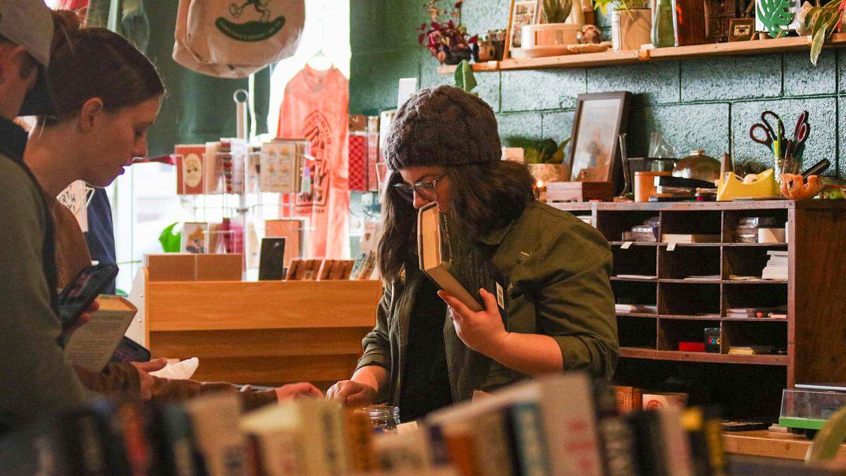 Customers check out books at Monstera’s Books in Overland Park Dec. 6, 2025.