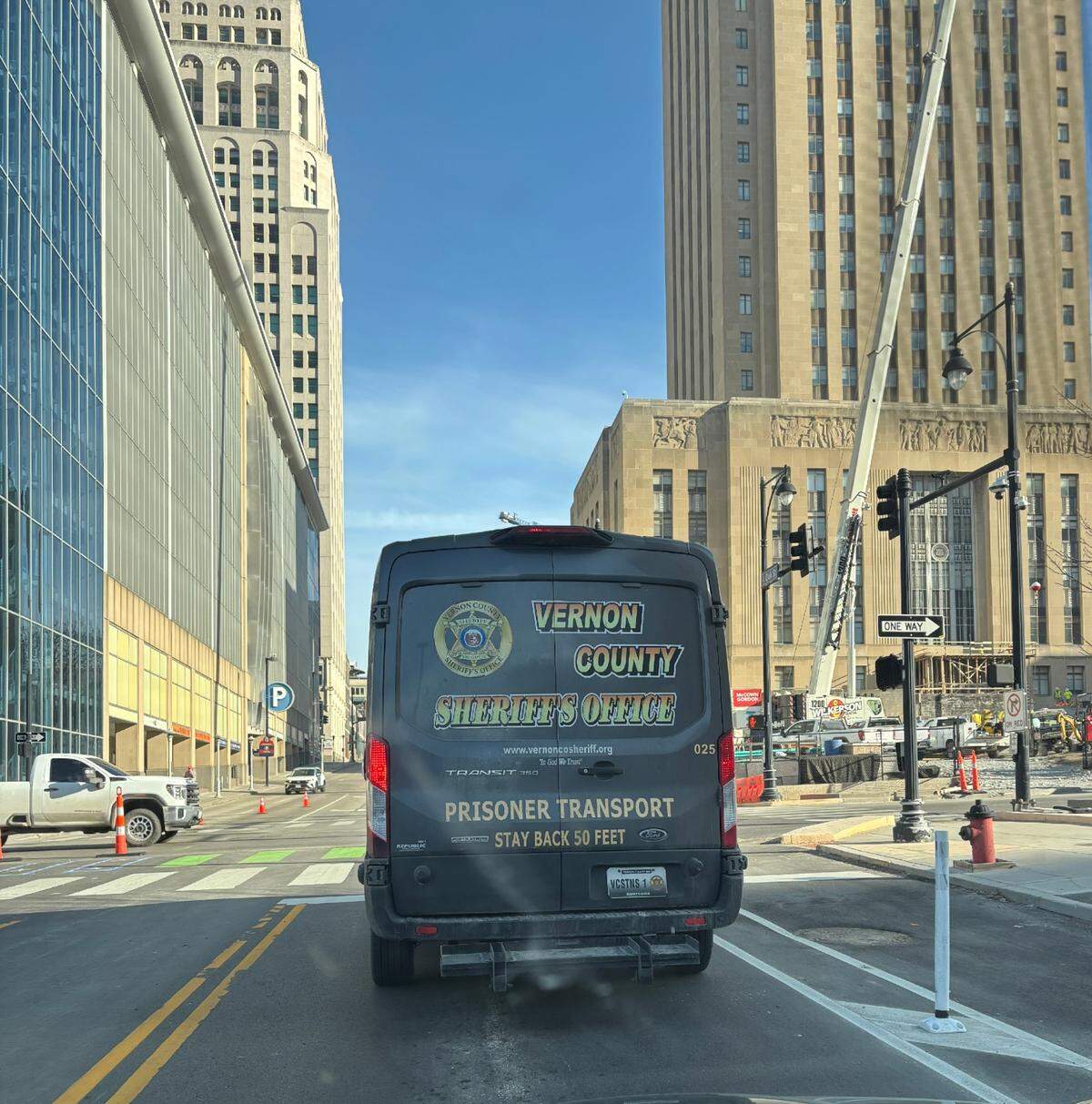 Vans from Vernon County transport Kansas City inmates to and from custody. KC City Hall is on the right.