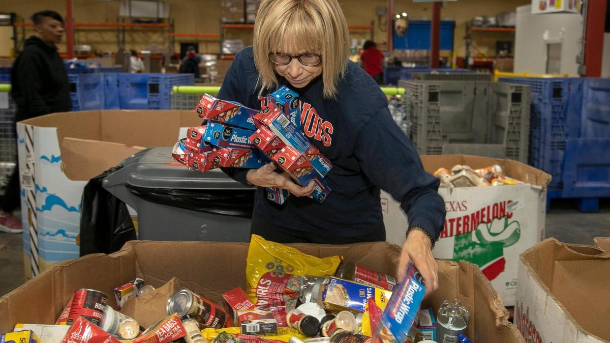 Diane Fennesy, of Lee’s Summit gathered boxes of plastic wrap Monday at Harvesters. Fennesy volunteered her time to help at the food bank like many people across Kansas City volunteered at other organizations to honor the legacy of Martin Luther King, Jr.
