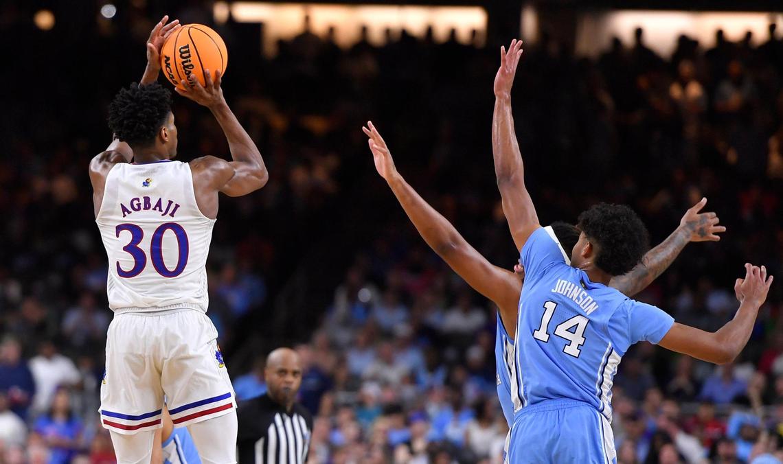 KU’s Ochai Agbaji shoots over a pair of UNC defenders during the first half of Monday night’s NCAA Championship game at the Superdome in New Orleans.