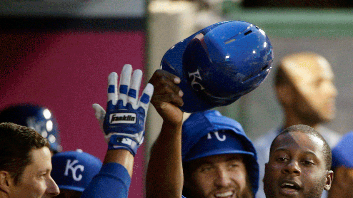 The Royals' Lorenzo Cain (center) was greeted by teammates after he scored on a single hit by Eric Hosmer during Friday's baseball game against the Angels in Anaheim, Calif.