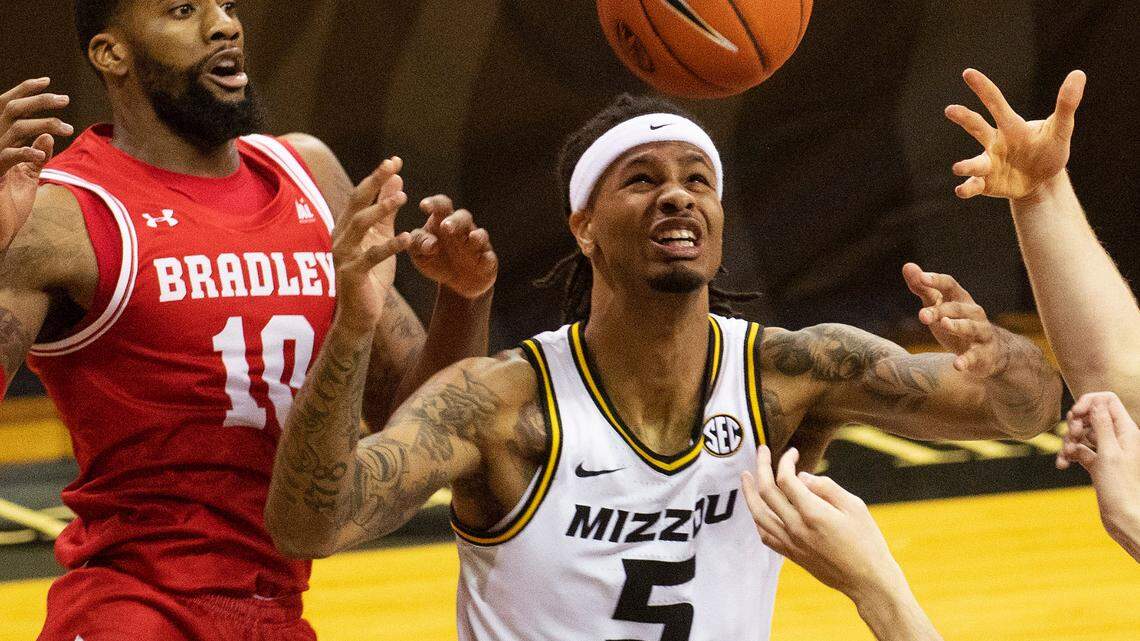 Bradley’s Elijah Childs, left, and Missouri’s Mitchell Smith, right, battle for a rebound during the first half of an NCAA college basketball game Tuesday, Dec. 22, 2020, in Columbia, Mo. (AP Photo/L.G. Patterson)