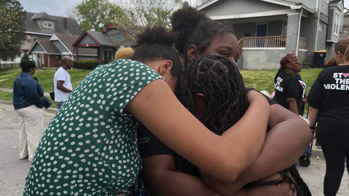 Kourtney Freeman’s friends and cousin hug after her vigil on April 15, 2024, less than a week after she was shot and killed in her Kansas City home