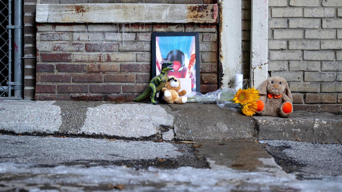 A makeshift memorial honors the child who was found dead in an alley near 10th Street and Grand Boulevard on Monday in downtown Kansas City. Police say the child died when they fell from a window of an apartment building.