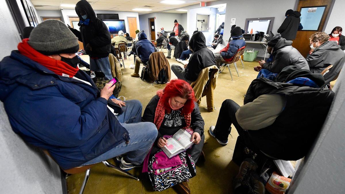 A woman reads the Bible at a Kansas City area warming shelter during a past winter storm.