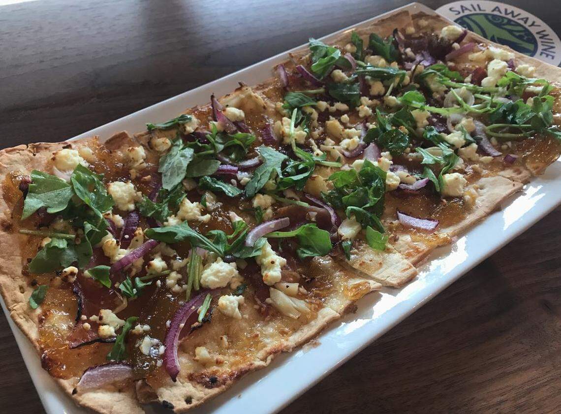 Sail Away Wine’s Ozark ham and fig flatbread pizza with goat cheese, roasted garlic, red onion, fig spread and arugula.