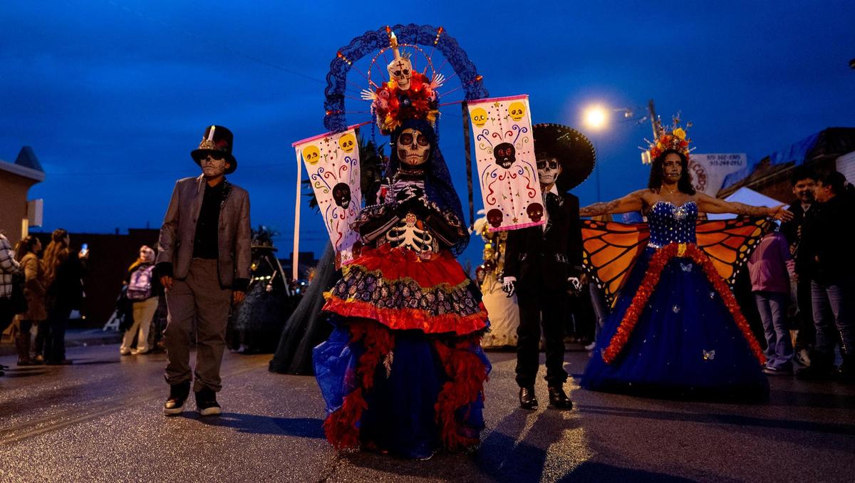 Danna Rivera, 7, dressed as a Catrina, walks during the Dia de los Muertos parade hosted by the Central Avenue Betterment Association on Saturday in Kansas City, Kan.