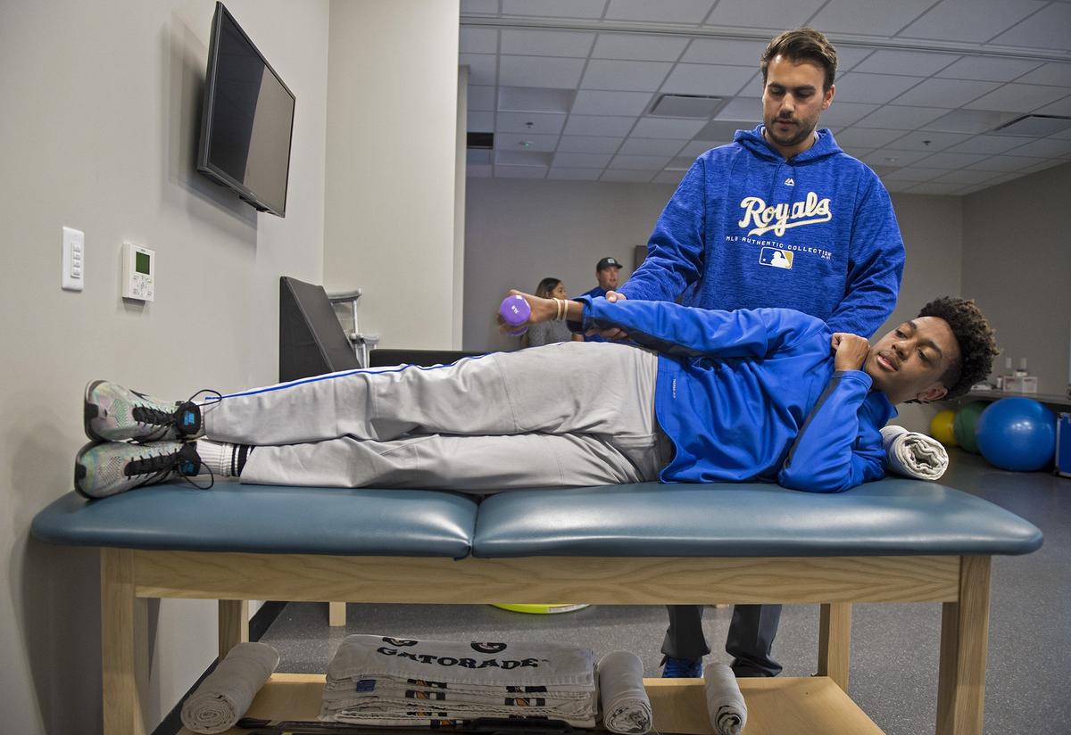 In the new training room at the Urban Youth Academy, Dylan Wilson, manager of sports medicine, worked with Jadin Wells, 16, a pitcher and shortstop for the Lincoln Prep baseball team.