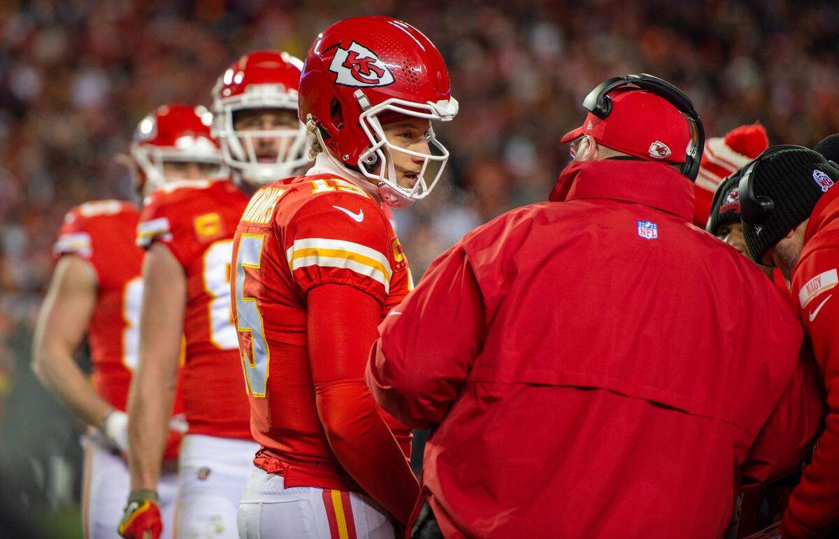 Kansas City Chiefs quarterback Patrick Mahomes speaks to head coach Andy Reid during a timeout at the AFC Championship Game against the Cincinnati Bengals at GEHA Field at Arrowhead Stadium on Sunday, Jan. 29, 2023, in Kansas City.
