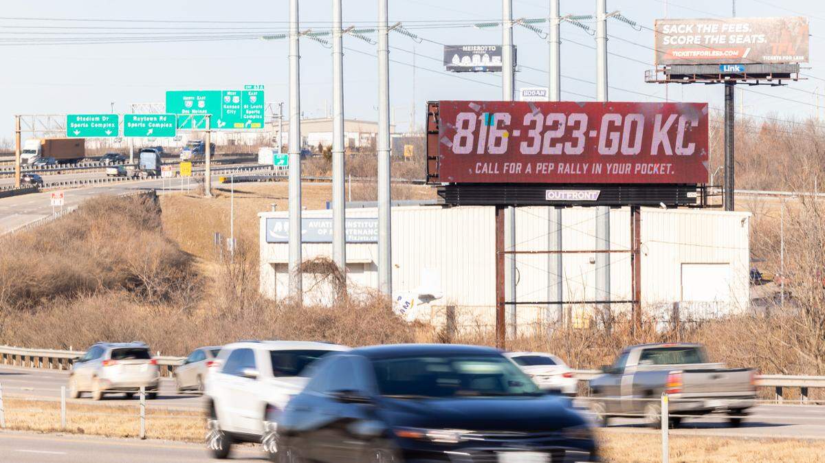 A billboard along Interstate 435 near Arrowhead Stadium invites onlookers to call for a “pep rally in your pocket.”