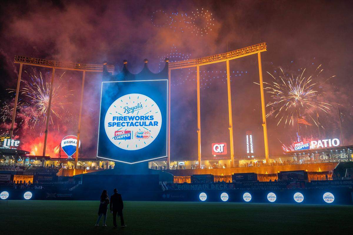 Lighted drones forming various shapes fly near fireworks Wednesday night where spectators watched a patriotic fireworks and drone display after the Kansas City Royals defeated the Tampa Bay Rays 4-2.