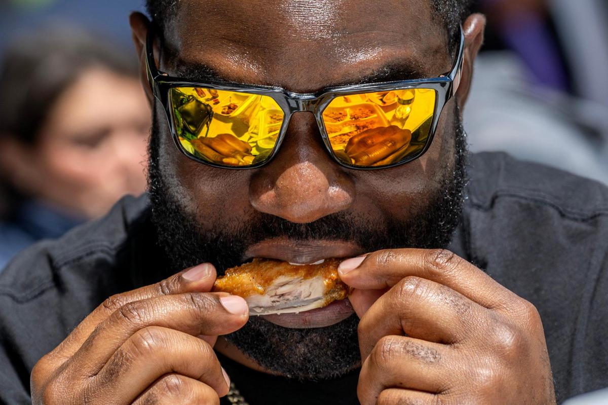 Malachi Daniels takes a bite of his food while attending the 4th Annual Taste of AAPI festival.